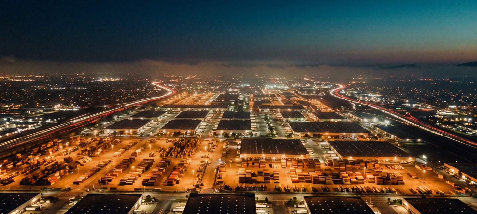 City skyline at night — global supply chain canvas